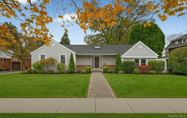 a front view of a house with a garden