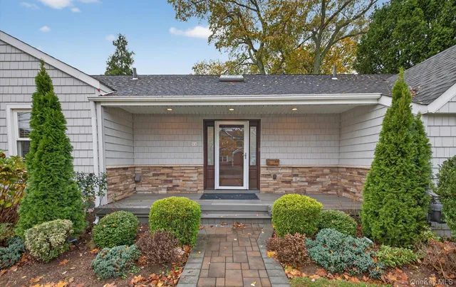 a front view of a house with garden