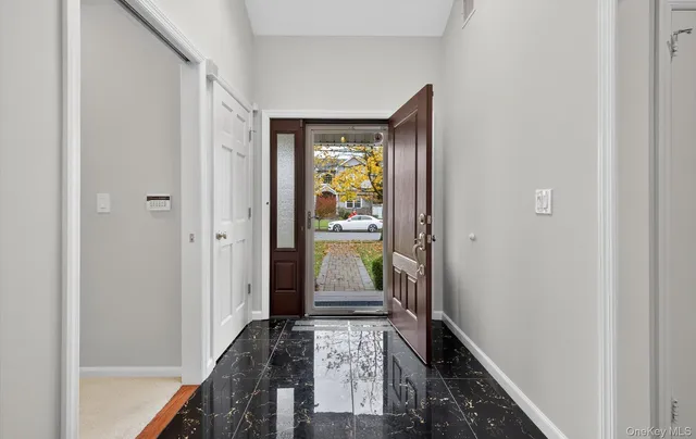 a hallway with dining area wooden floor and front door