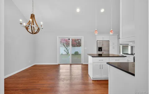 a kitchen with a sink cabinets and wooden floor