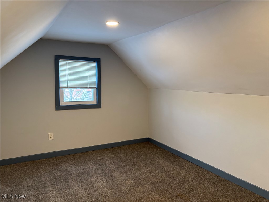 17914 Libby Road Maple Heights, OH 44137 - Photo 7 of 17 Bonus room with dark carpet and vaulted ceiling