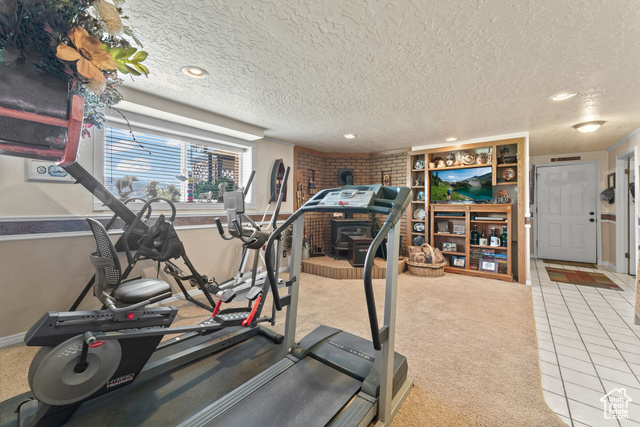 6407 North Dry Frk Cyn Road West Vernal, UT 84078 - Photo 37 of 48 Workout area featuring tile patterned floors, a textured ceiling, recessed lighting, baseboards, and carpet flooring