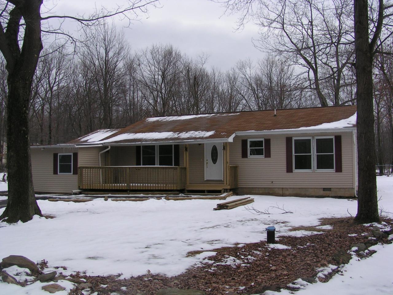 a front view of a house with trees