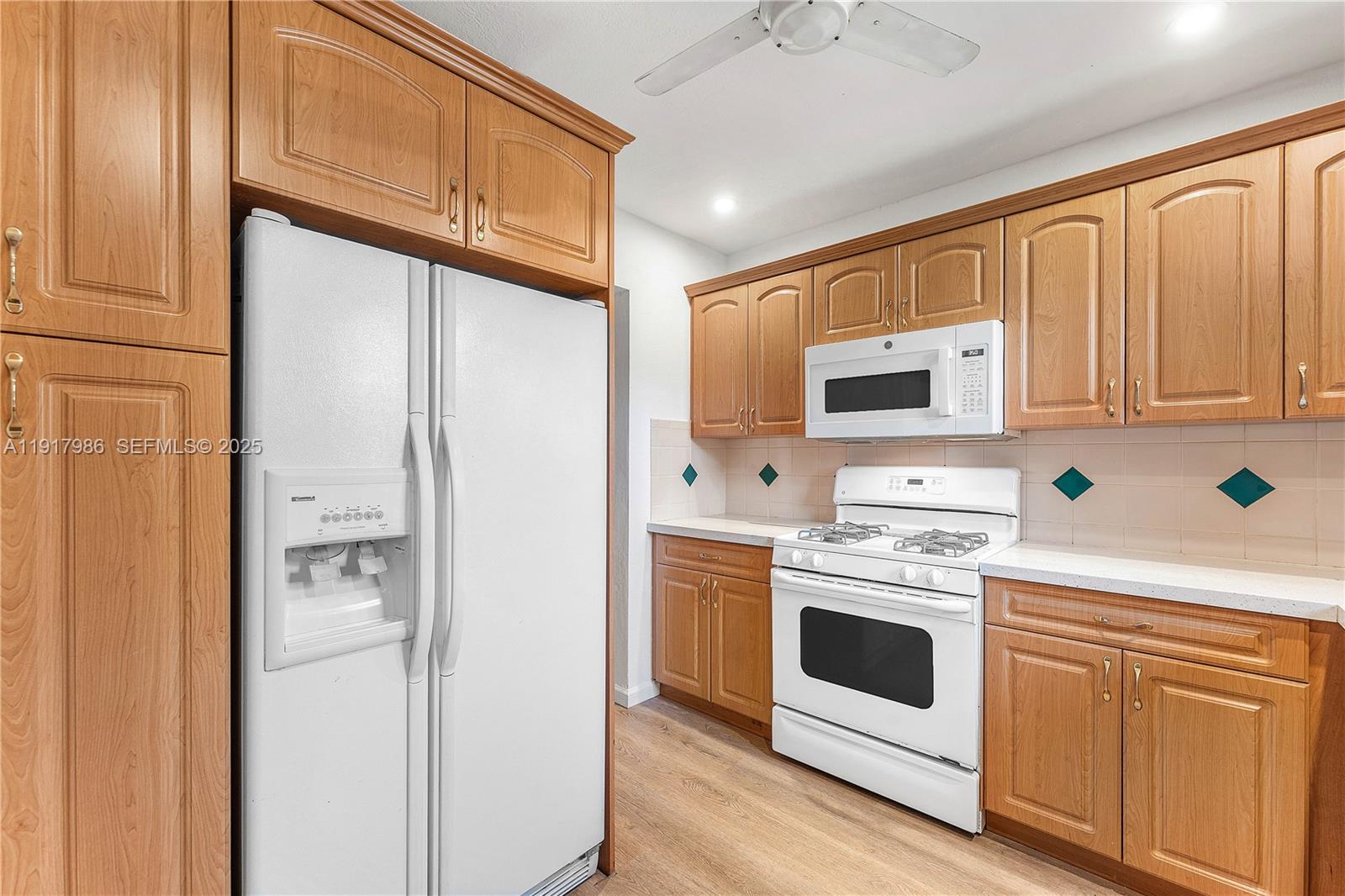 475 Northwest 46th Terrace Plantation, FL 33317 - Photo 11 of 43 a kitchen with white cabinets and white appliances