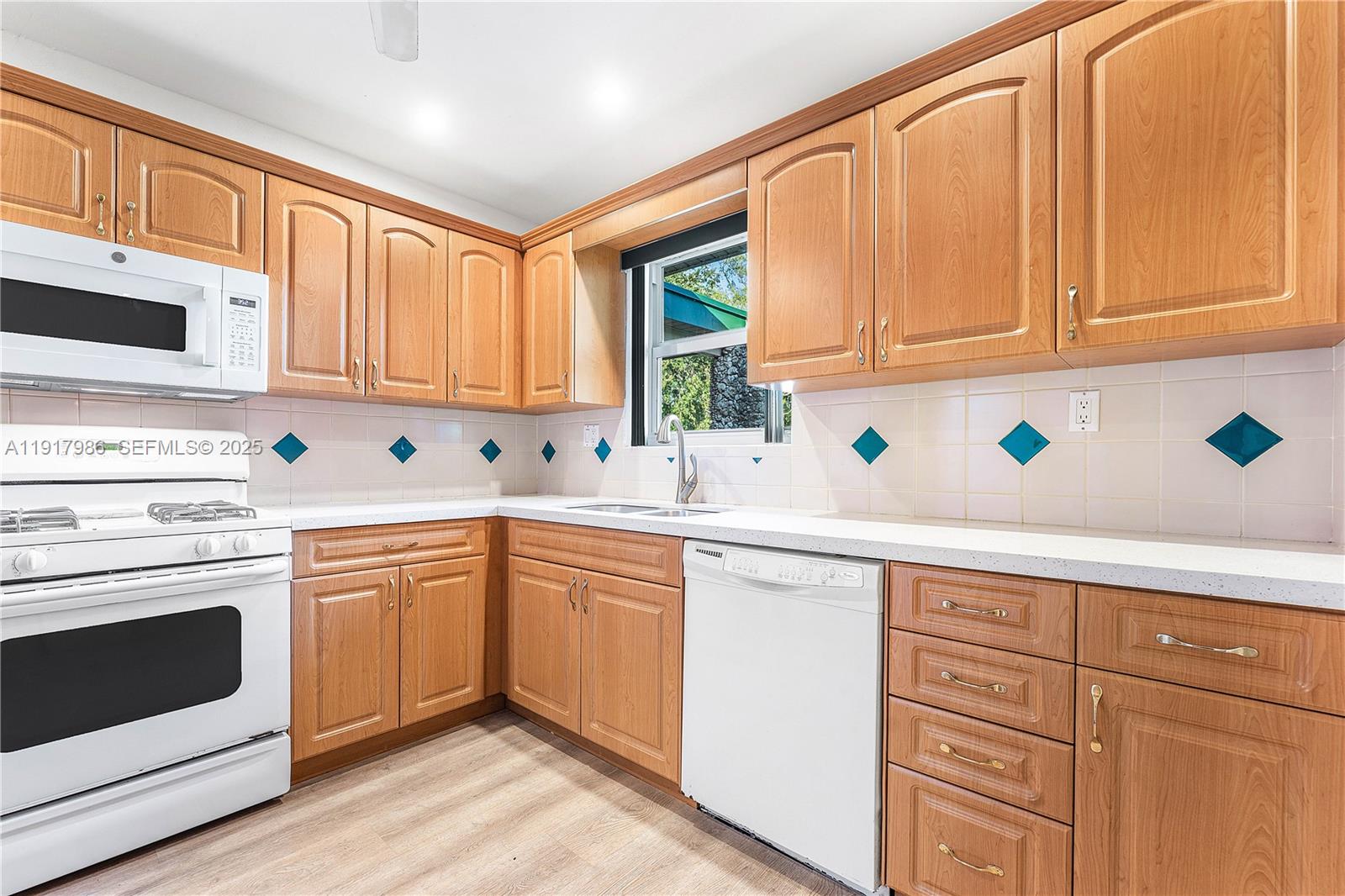 475 Northwest 46th Terrace Plantation, FL 33317 - Photo 12 of 43 a kitchen with granite countertop cabinets stainless steel appliances and sink