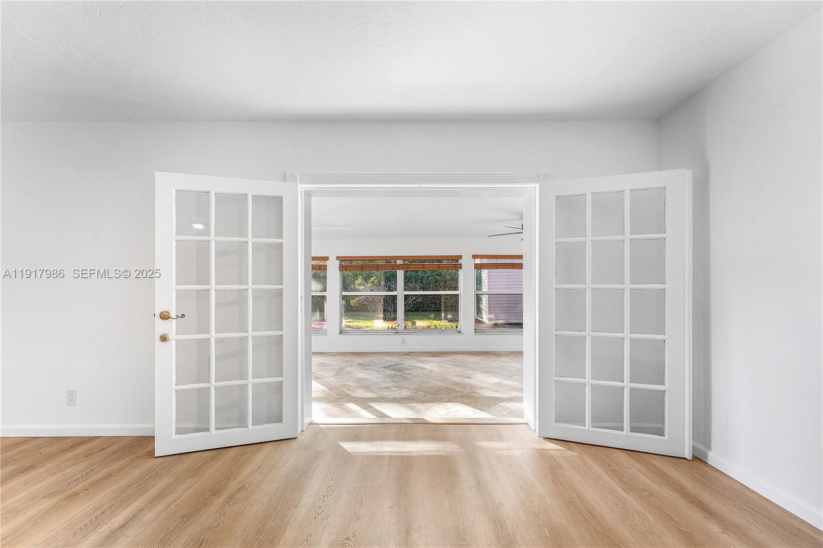 475 Northwest 46th Terrace Plantation, FL 33317 - Photo 15 of 43 an empty room with wooden floor and windows