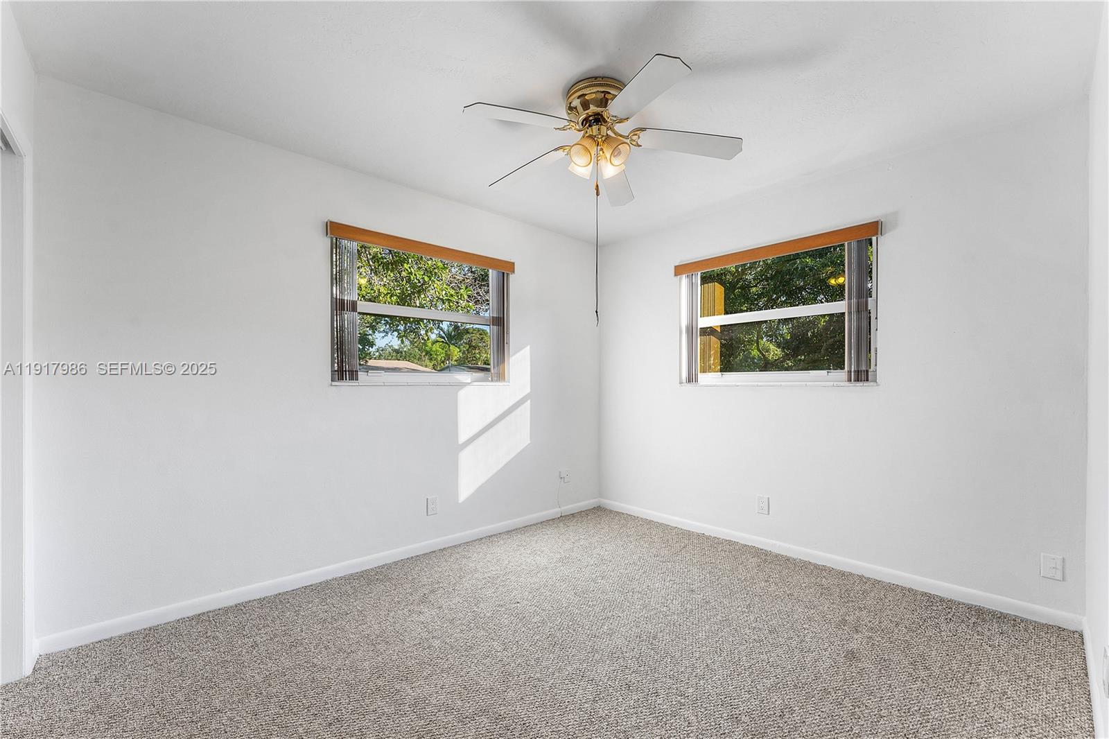 475 Northwest 46th Terrace Plantation, FL 33317 - Photo 19 of 43 an empty room with windows and fan
