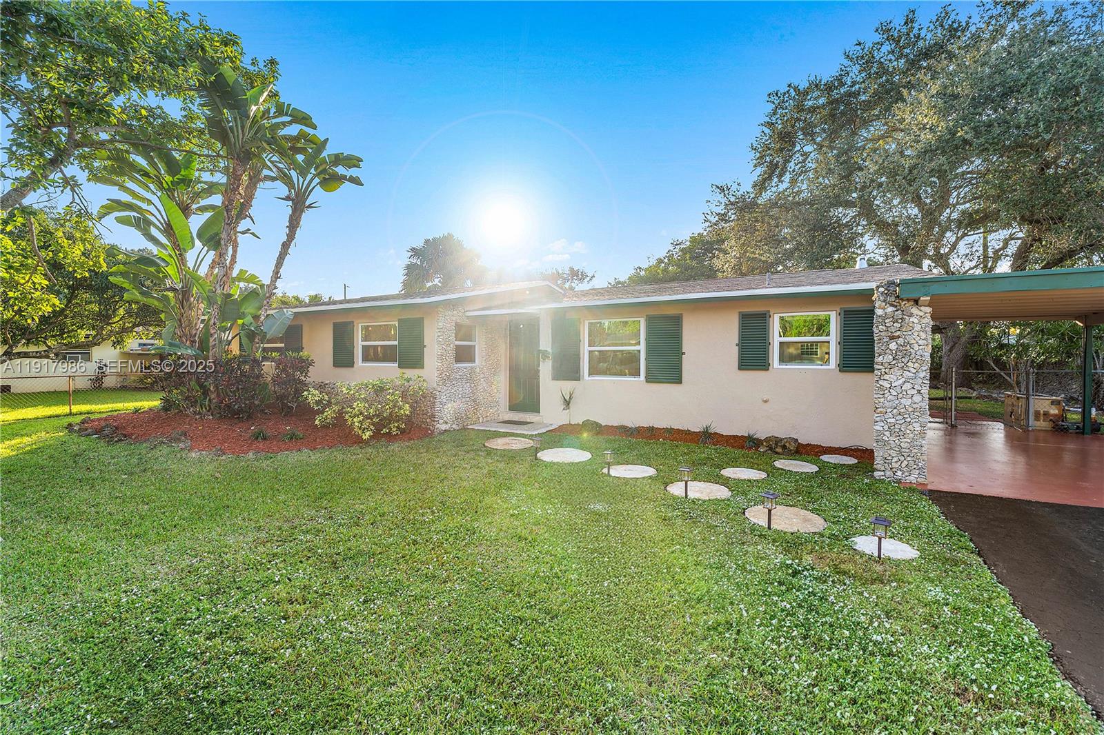475 Northwest 46th Terrace Plantation, FL 33317 - Photo 3 of 43 a backyard of a house with table and chairs and potted plants