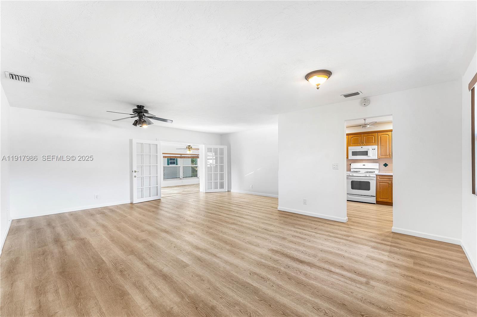 475 Northwest 46th Terrace Plantation, FL 33317 - Photo 6 of 43 a view of empty room with wooden floor and windows