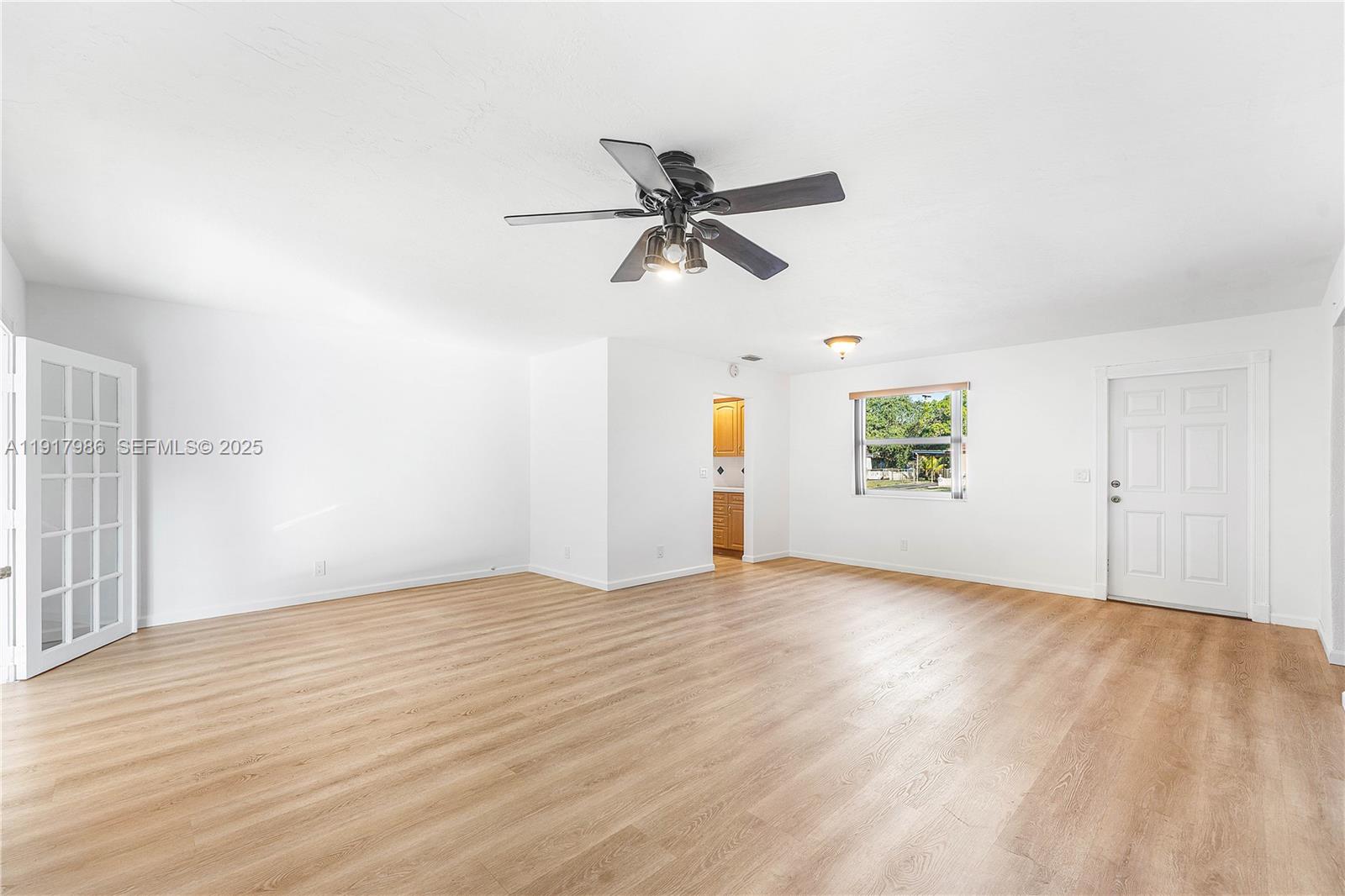 475 Northwest 46th Terrace Plantation, FL 33317 - Photo 7 of 43 an empty room with windows and fan