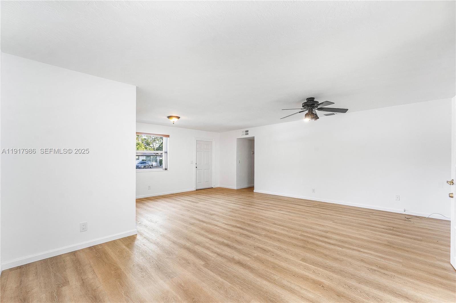 475 Northwest 46th Terrace Plantation, FL 33317 - Photo 8 of 43 an empty room with wooden floor and windows