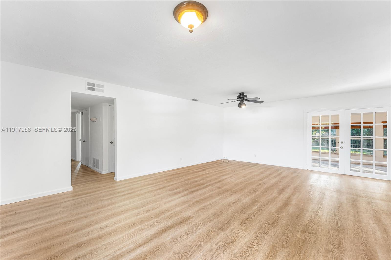 475 Northwest 46th Terrace Plantation, FL 33317 - Photo 9 of 43 an empty room with wooden floor and windows