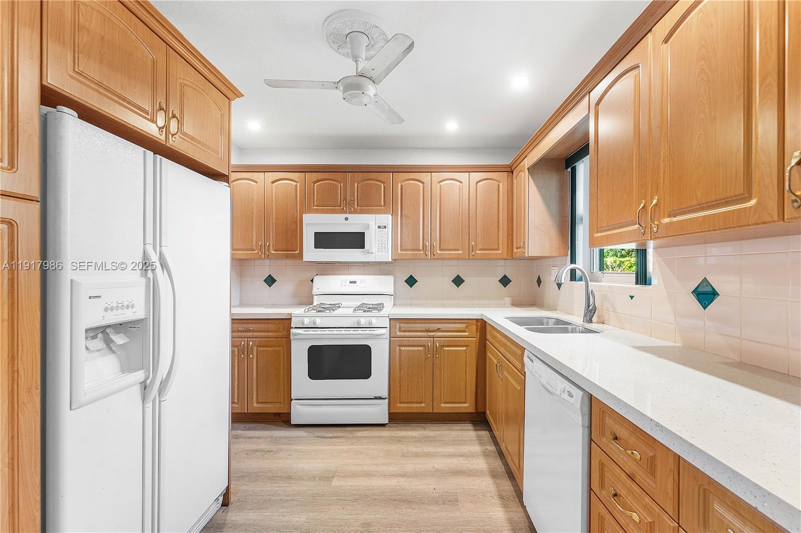 475 Northwest 46th Terrace Plantation, FL 33317 - Photo 10 of 43 a kitchen with stainless steel appliances a stove sink refrigerator and cabinets