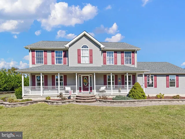 a front view of a house with swimming pool having outdoor seating