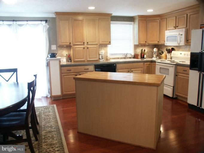 61 Yew Road Baltimore, MD 21221 - Photo 11 of 30 a kitchen with sink cabinets and wooden floor