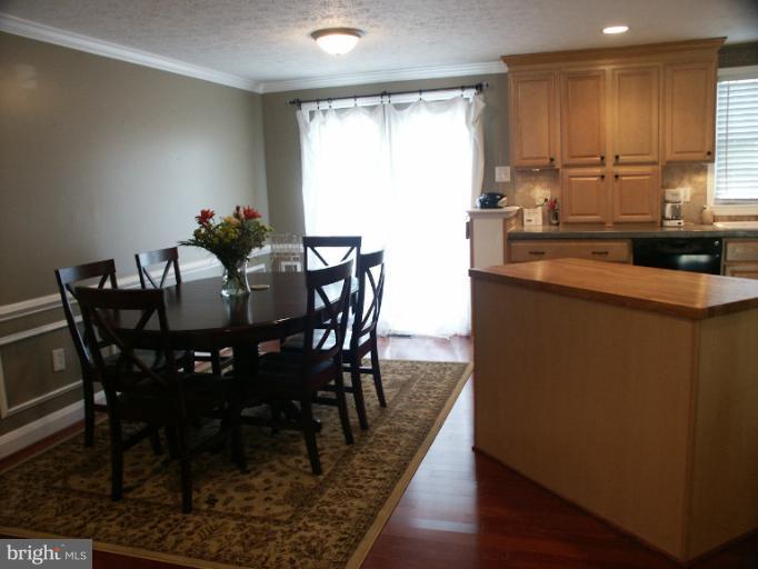 61 Yew Road Baltimore, MD 21221 - Photo 12 of 30 a view of a dining room with furniture and wooden floor