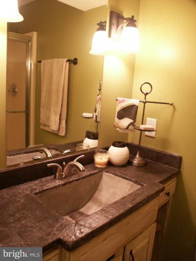61 Yew Road Baltimore, MD 21221 - Photo 15 of 30 a bathroom with a granite countertop sink and a mirror