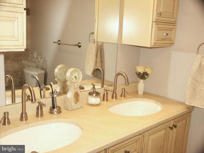 61 Yew Road Baltimore, MD 21221 - Photo 16 of 30 a bathroom with double vanity sinks and a mirror