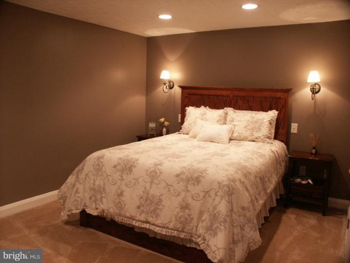 61 Yew Road Baltimore, MD 21221 - Photo 17 of 30 a large bed sitting in a bedroom next to a lamp