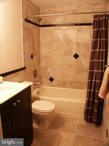 61 Yew Road Baltimore, MD 21221 - Photo 18 of 30 a bathroom with a shower a toilet and sink