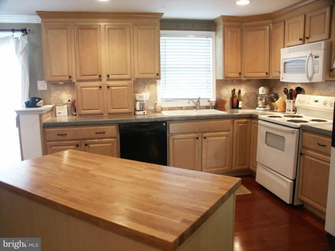 61 Yew Road Baltimore, MD 21221 - Photo 3 of 30 a kitchen with a sink stove and cabinets