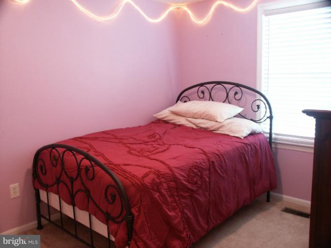 61 Yew Road Baltimore, MD 21221 - Photo 21 of 30 a bedroom with a bed and a mirror