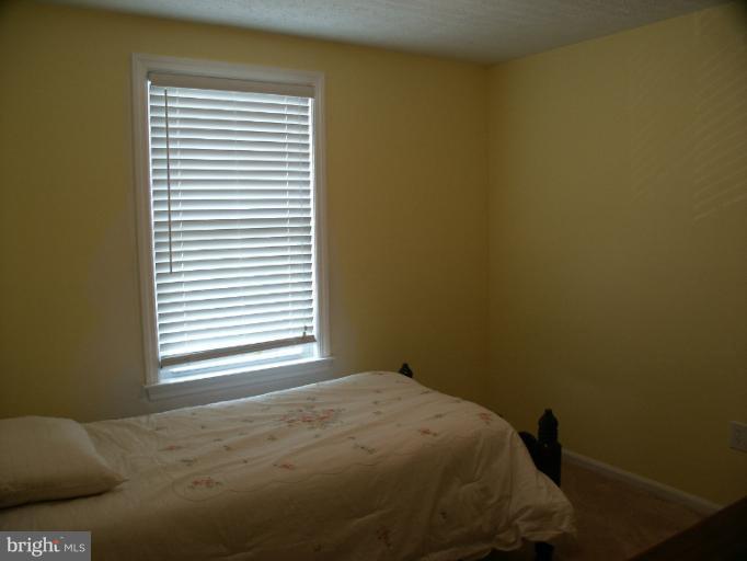 61 Yew Road Baltimore, MD 21221 - Photo 23 of 30 a bedroom with a bed and a window