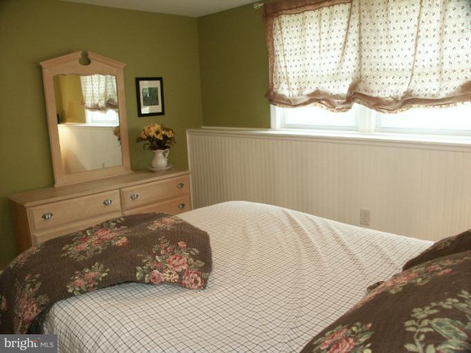 61 Yew Road Baltimore, MD 21221 - Photo 5 of 30 a bedroom with a bed and a window