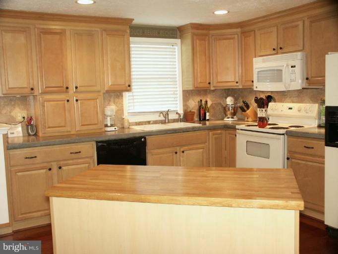 61 Yew Road Baltimore, MD 21221 - Photo 6 of 30 a kitchen with stainless steel appliances granite countertop a sink and a stove