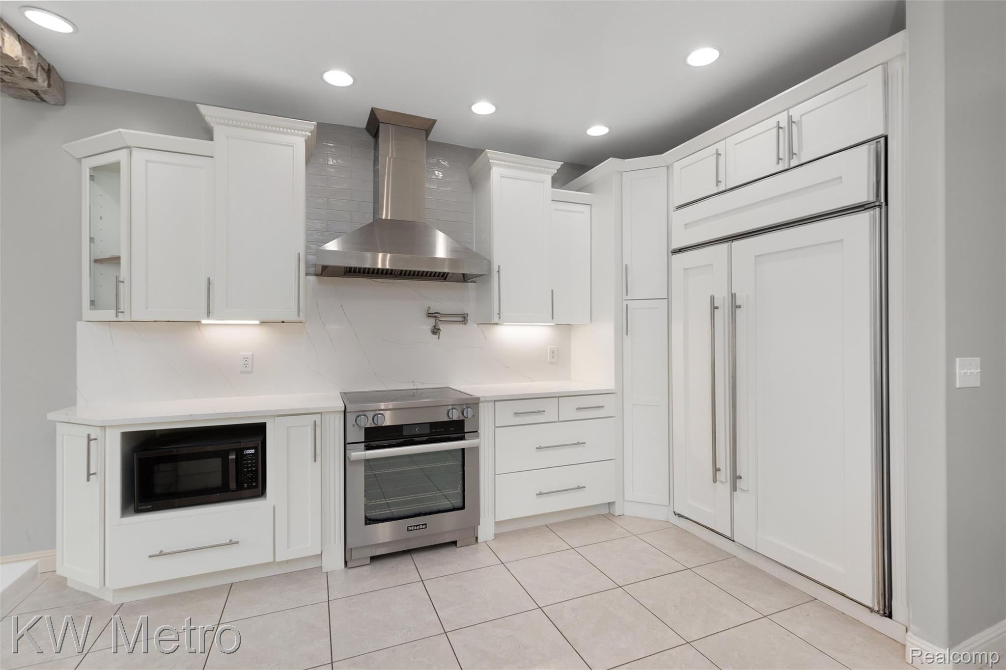 65884 Windrose Court Ray, MI 48096 - Photo 39 of 82 Kitchen featuring white cabinetry, high end appliances, decorative backsplash, and recessed lighting