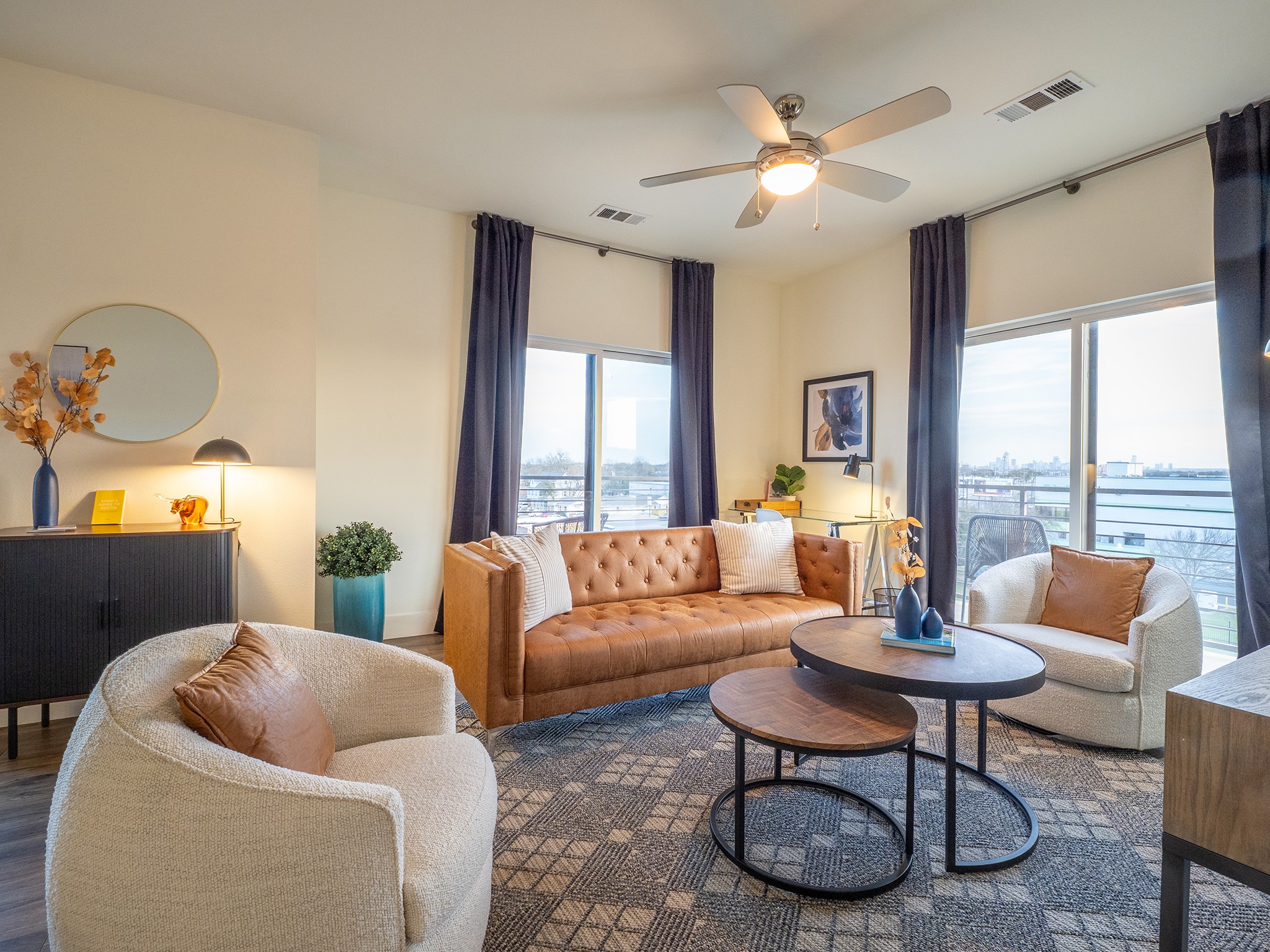 Living room featuring ceiling fan, wood finished floors, and a water view