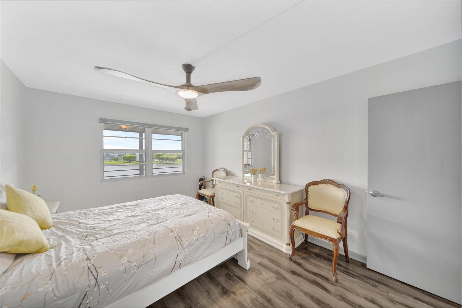 4063 Exeter Boca Raton, FL 33434 - Photo 21 of 55 a bedroom with a bed a chandelier and a window