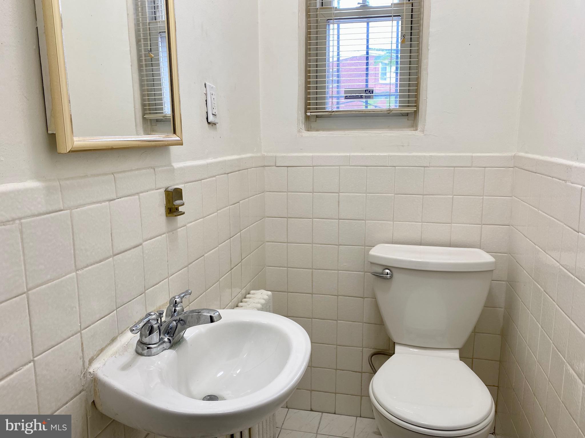 7527 8th Street Northwest Washington, DC 20012 - Photo 11 of 18 a bathroom with a toilet sink and mirror