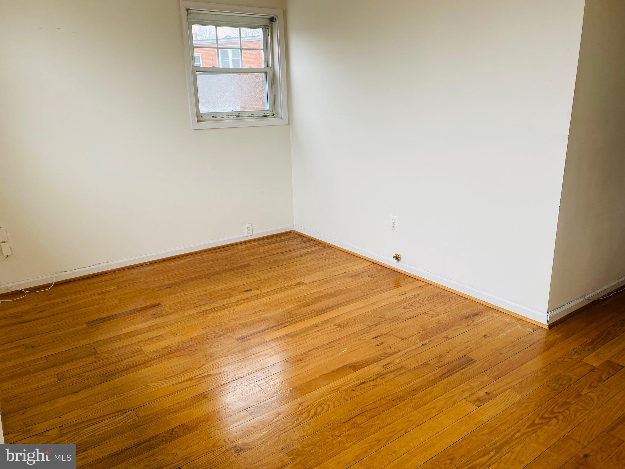 7527 8th Street Northwest Washington, DC 20012 - Photo 13 of 18 an empty room with wooden floor and windows