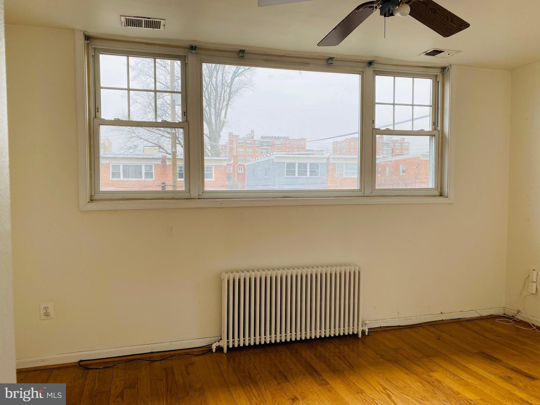 7527 8th Street Northwest Washington, DC 20012 - Photo 14 of 18 an empty room with wooden floor and windows