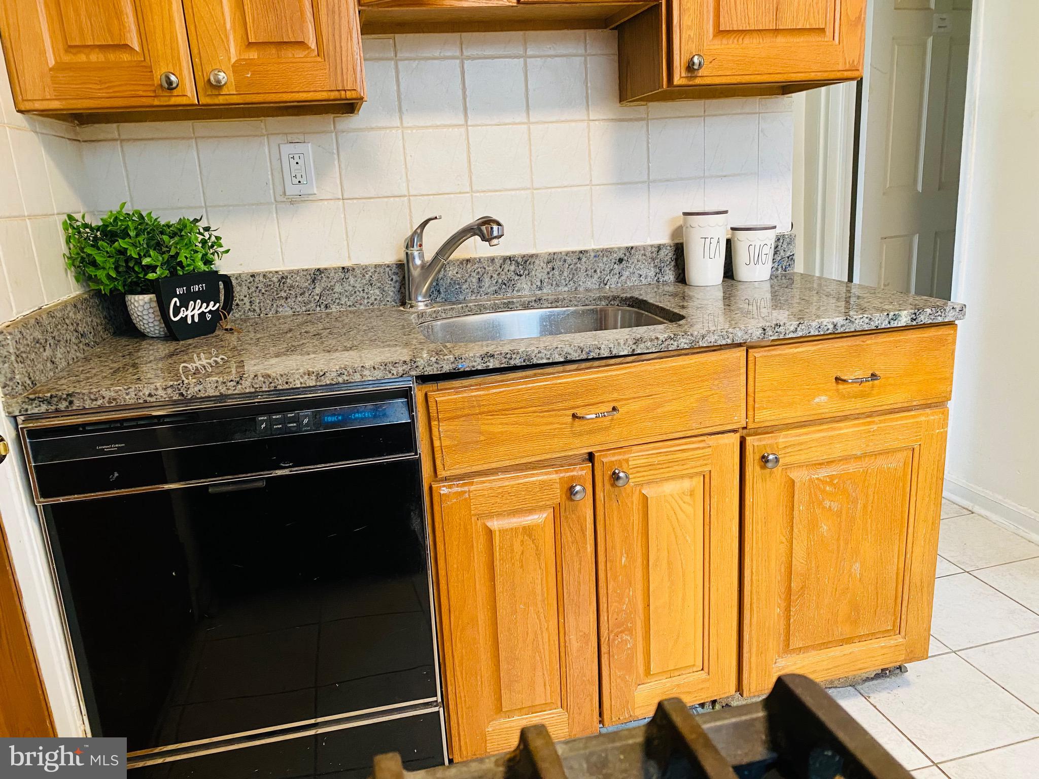 7527 8th Street Northwest Washington, DC 20012 - Photo 8 of 18 a kitchen with granite countertop stainless steel appliances a sink stove and cabinets