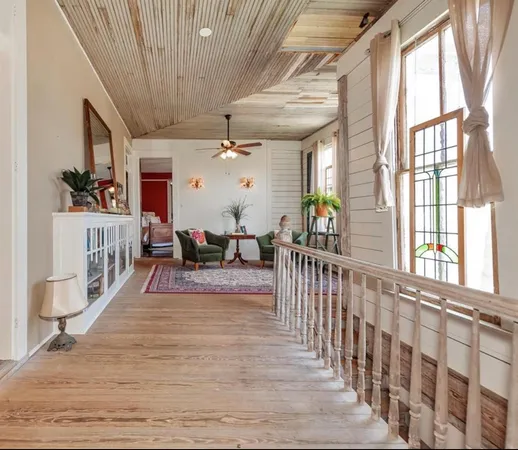 a bedroom with a bed couch and a window
