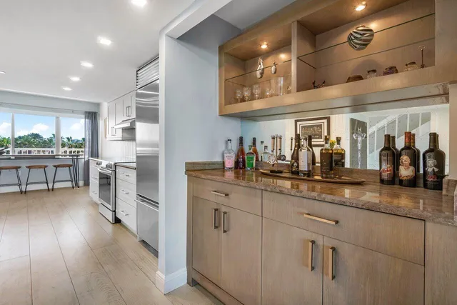 a kitchen with stainless steel appliances granite countertop a lot of counter space and wooden floors