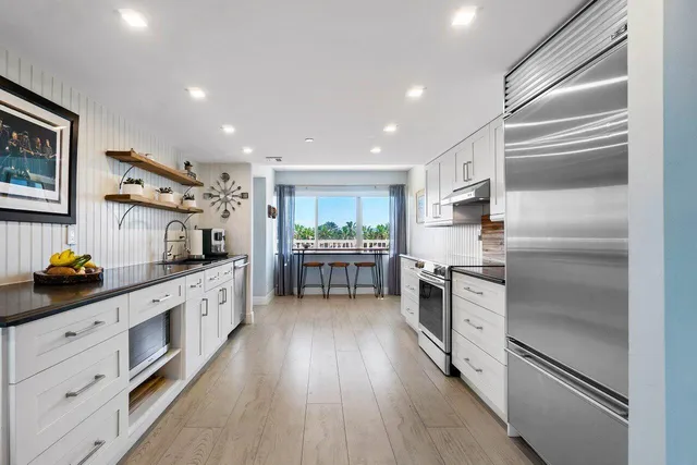 a kitchen with granite countertop a refrigerator and a stove