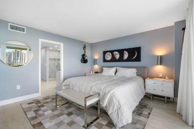 a bedroom with a bed and a lamp