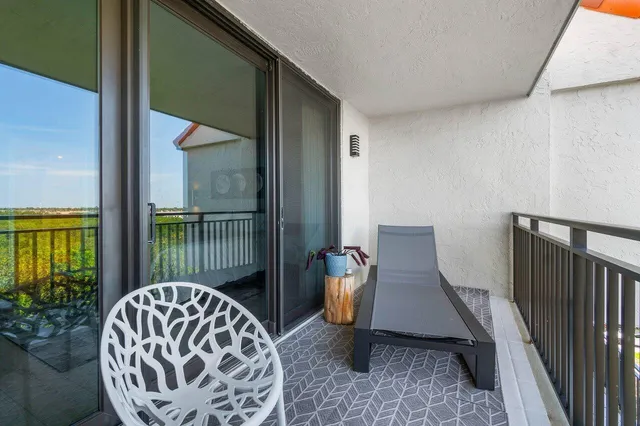 a view of a bedroom with furniture and windows