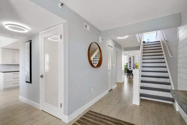 a view of entryway with stairs and wooden floor