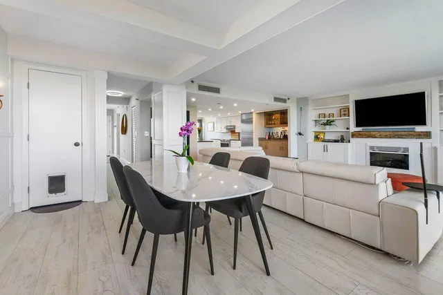 a view of a livingroom with furniture a flat screen tv and a fireplace
