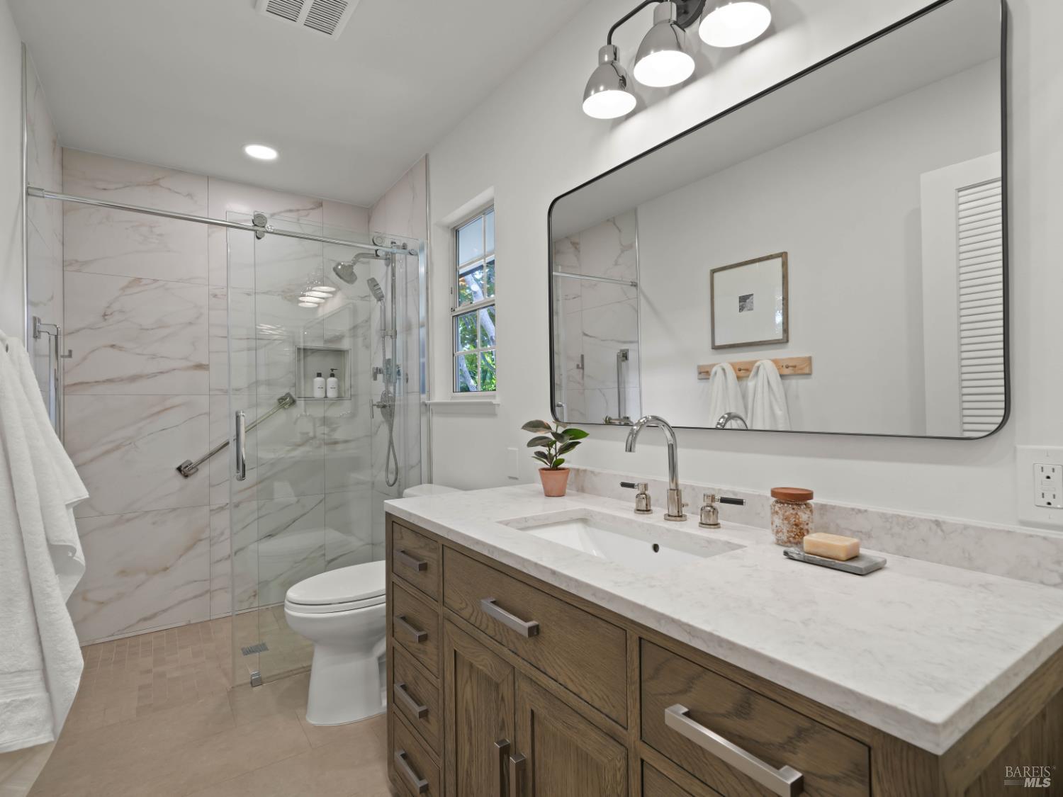 148 Dominican Drive San Rafael, CA 94901 - Photo 32 of 60 a bathroom with a sink toilet double vanity and shower
