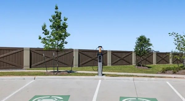 a view of a park with iron fence