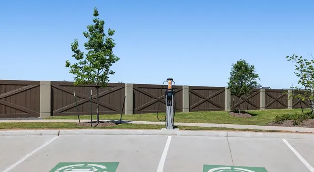 a view of a park with iron fence