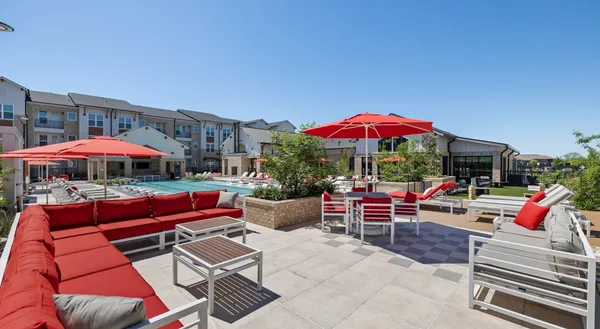 a view of a patio with a dining table and chairs under an umbrella