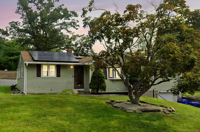 a view of house with a yard