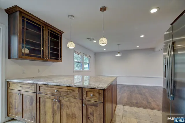 a kitchen with kitchen island a counter top space appliances and cabinets