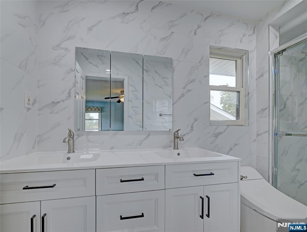 819 Ridgewood Road Millburn, NJ 07041 - Photo 19 of 39 a bathroom with a sink and a toilet